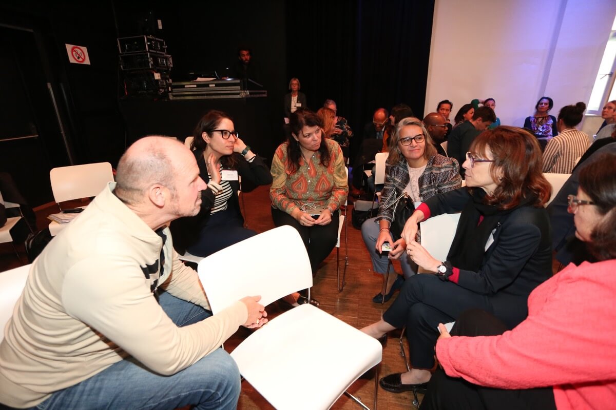 Participants exchange ideas and impressions in small discussion groups